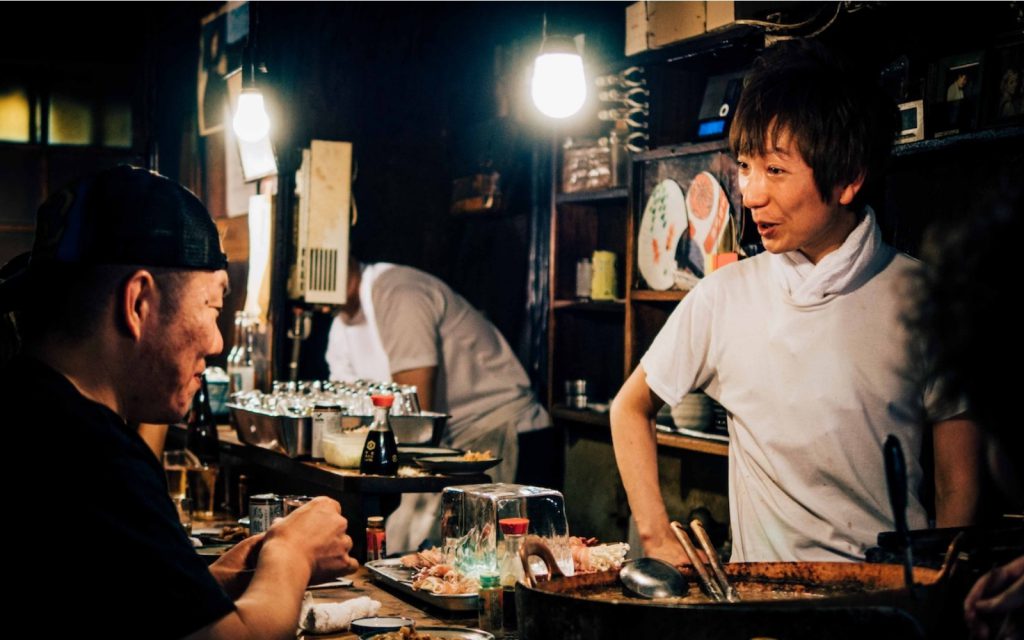 Chatting in a bar shotengai Japan