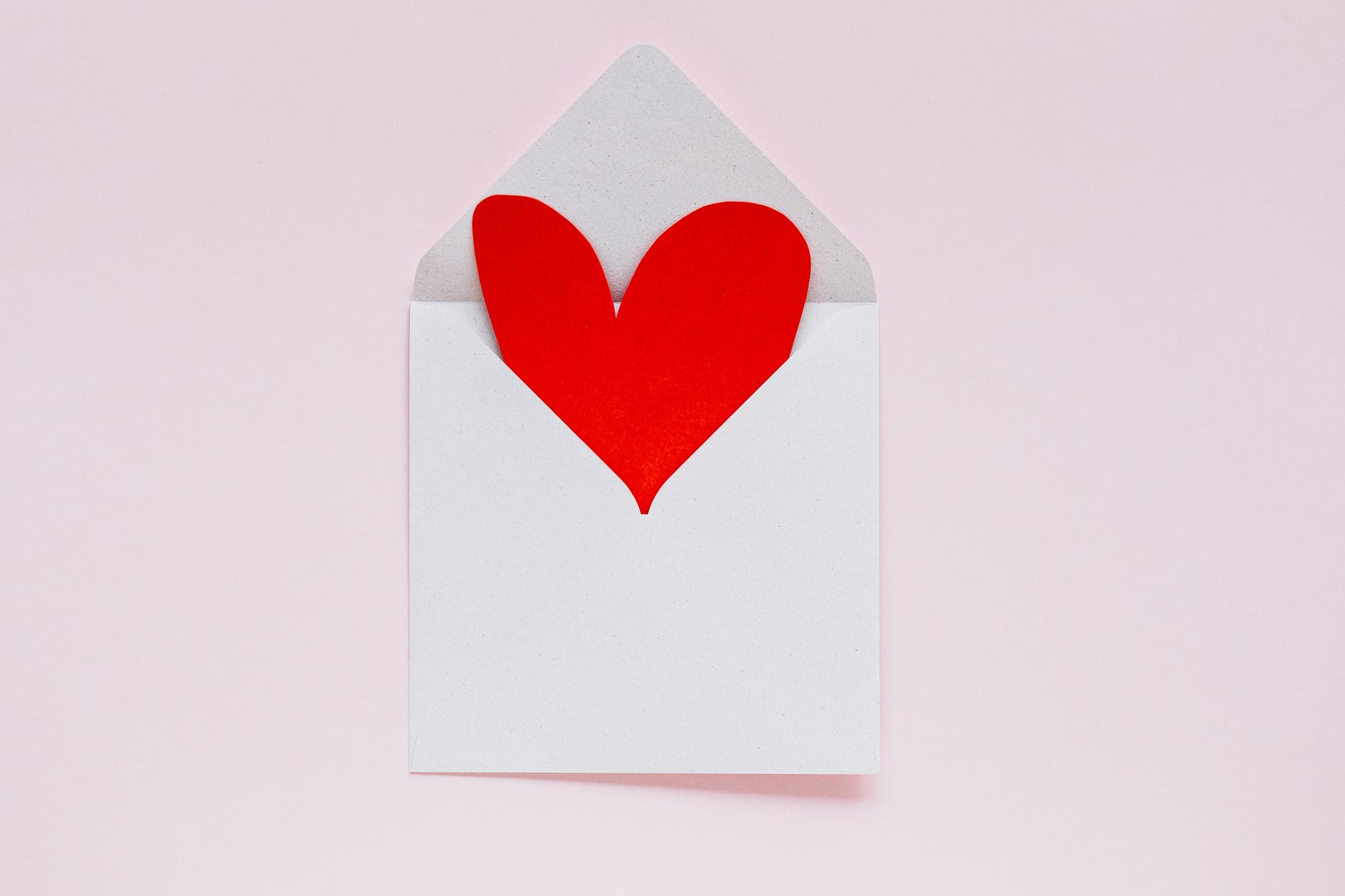 open envelope with heart made of colored carton