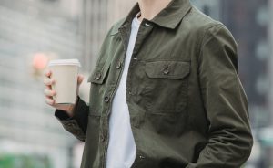 unrecognizable man drinking takeaway coffee in downtown
