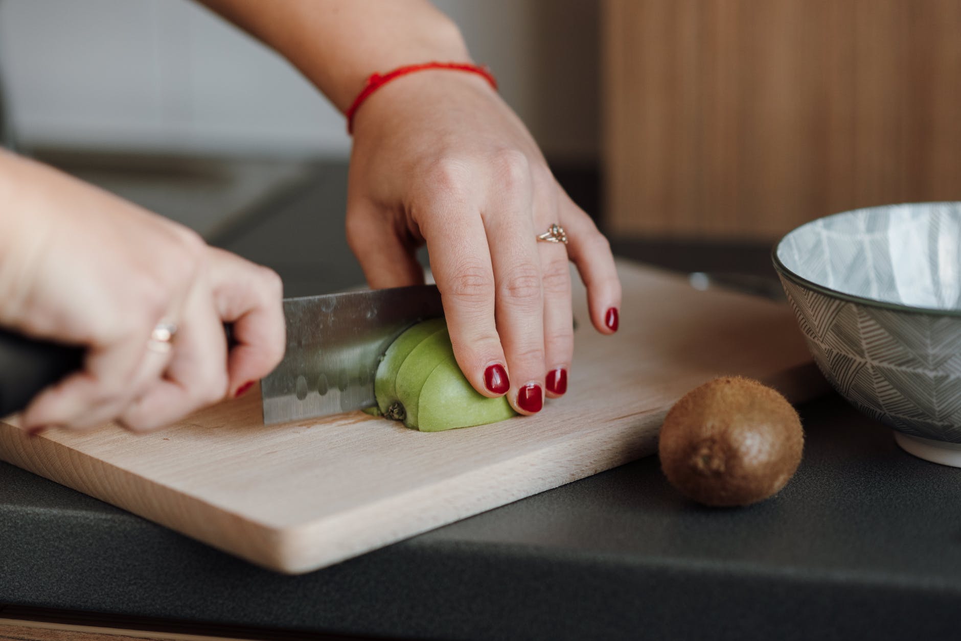 woman cutting fresh green apple