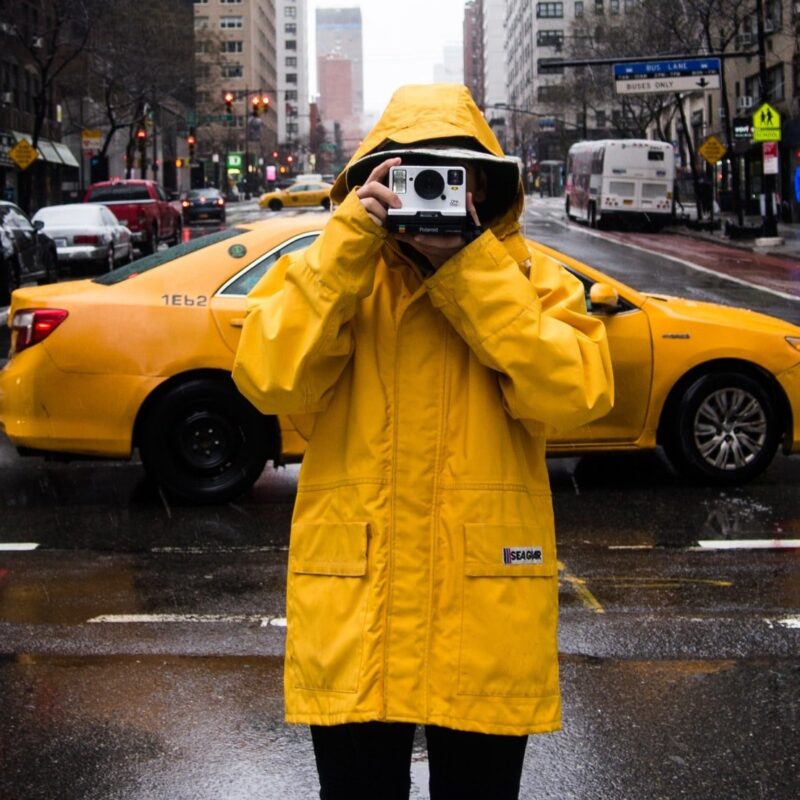 person in raincoat taking pho20e587 800x800 1