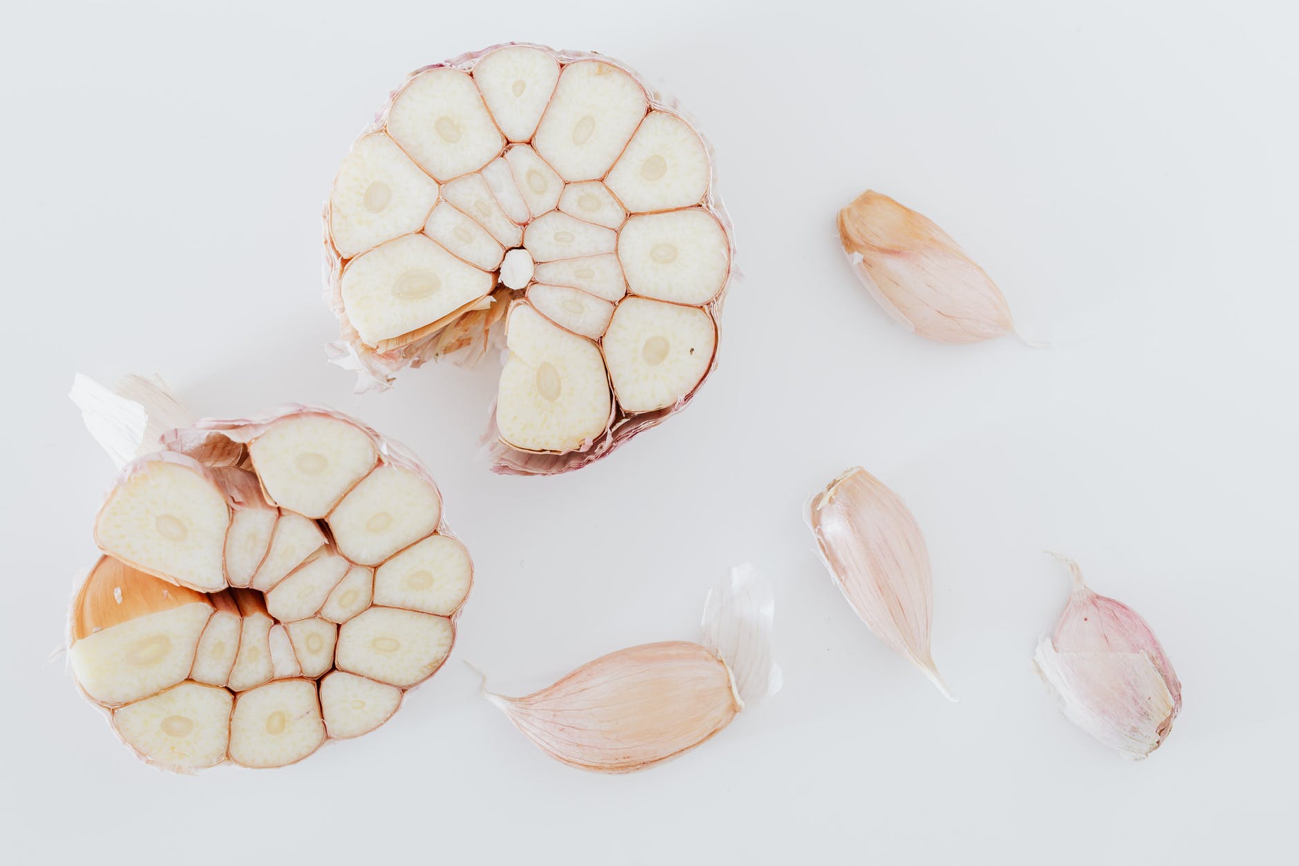 composition of cut in half and pieces of garlic