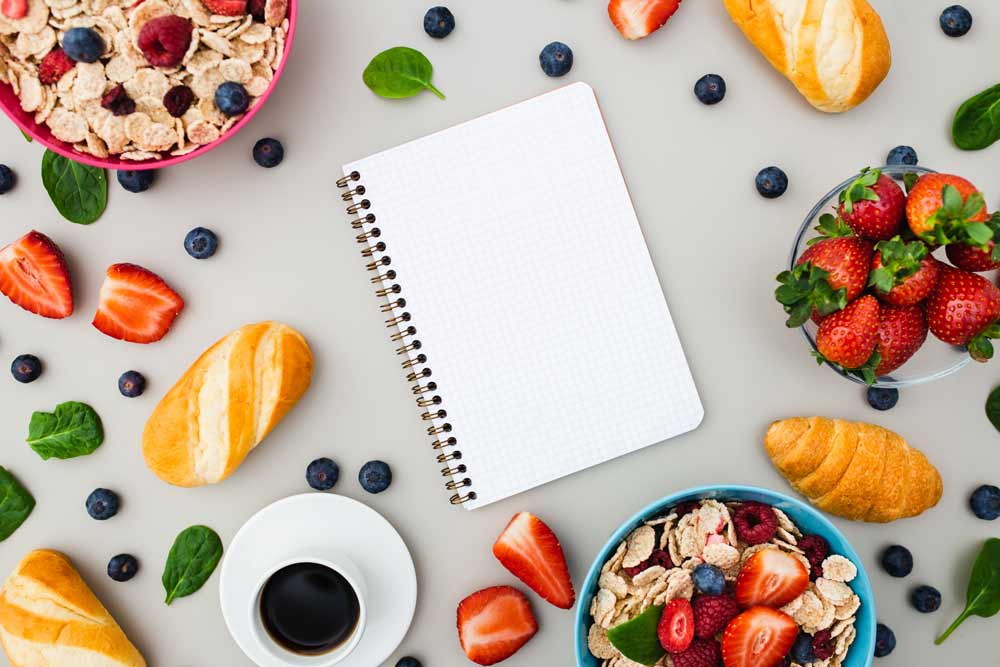 diary surrounded by healthy foods
